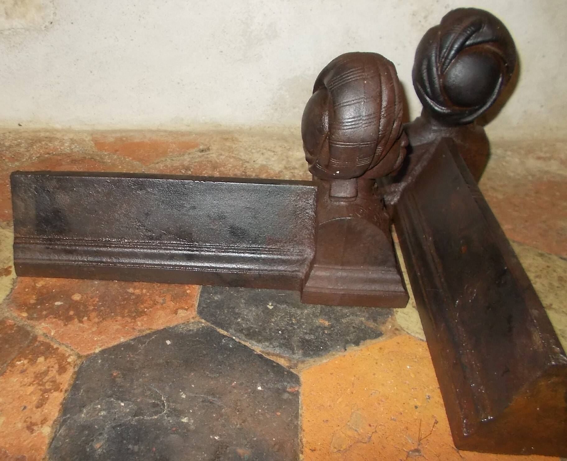 Old cast iron andirons with oriental decor