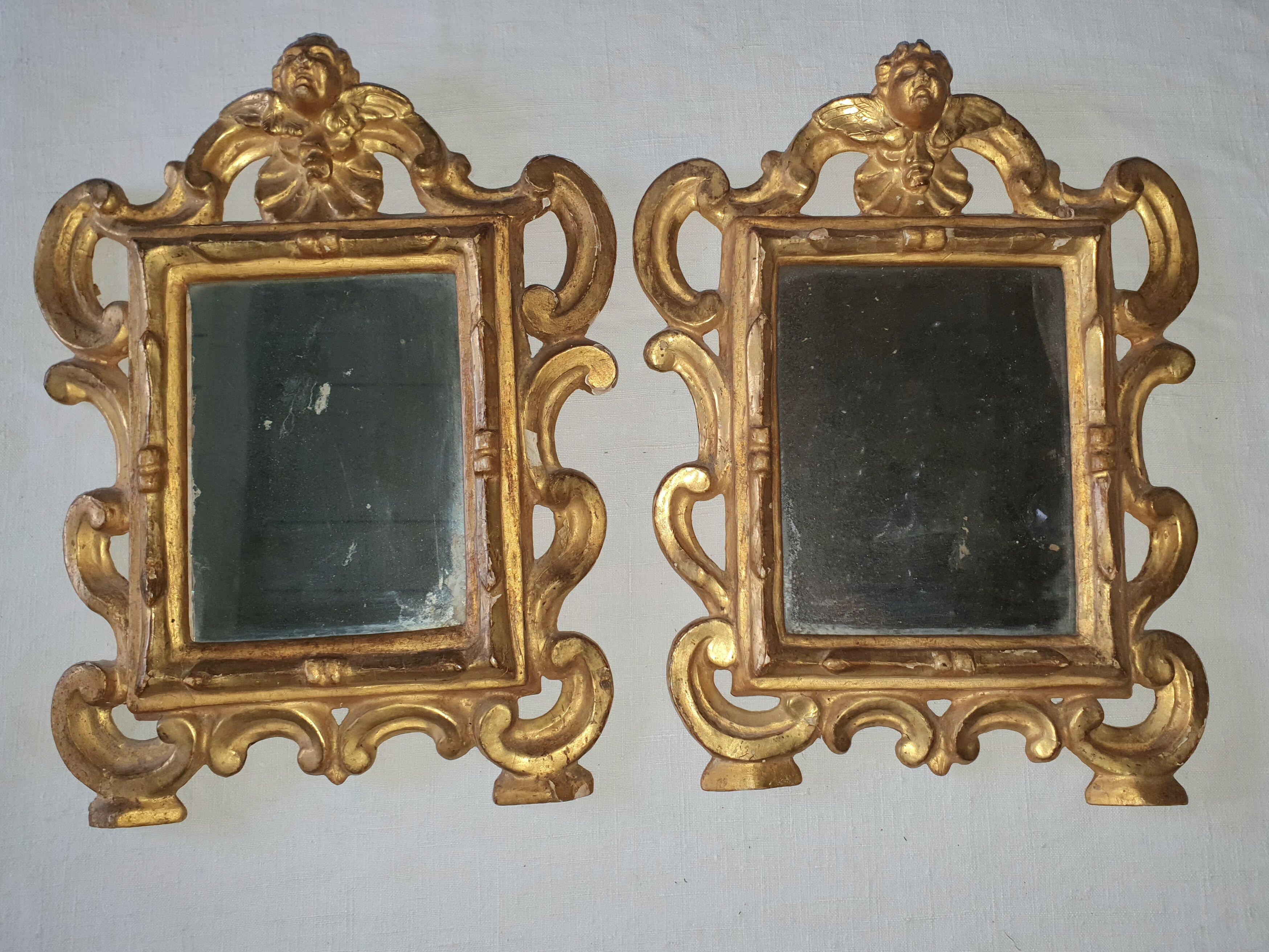 Pair of gilded wooden mirrors with cherub decoration 27x35cm