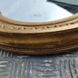 Antique oval mirror in gilded stucco with gold leaf, 19th century