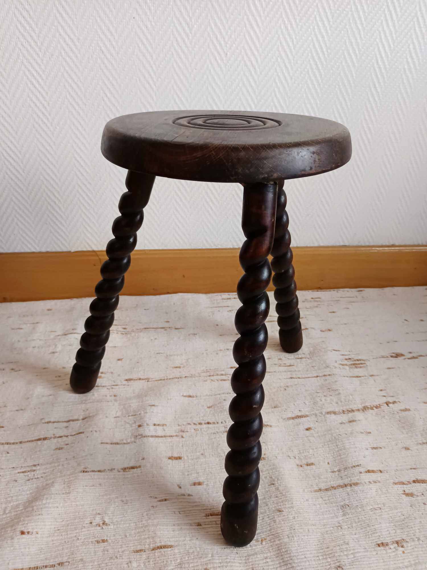 Brutalist tripod stool with twisted legs