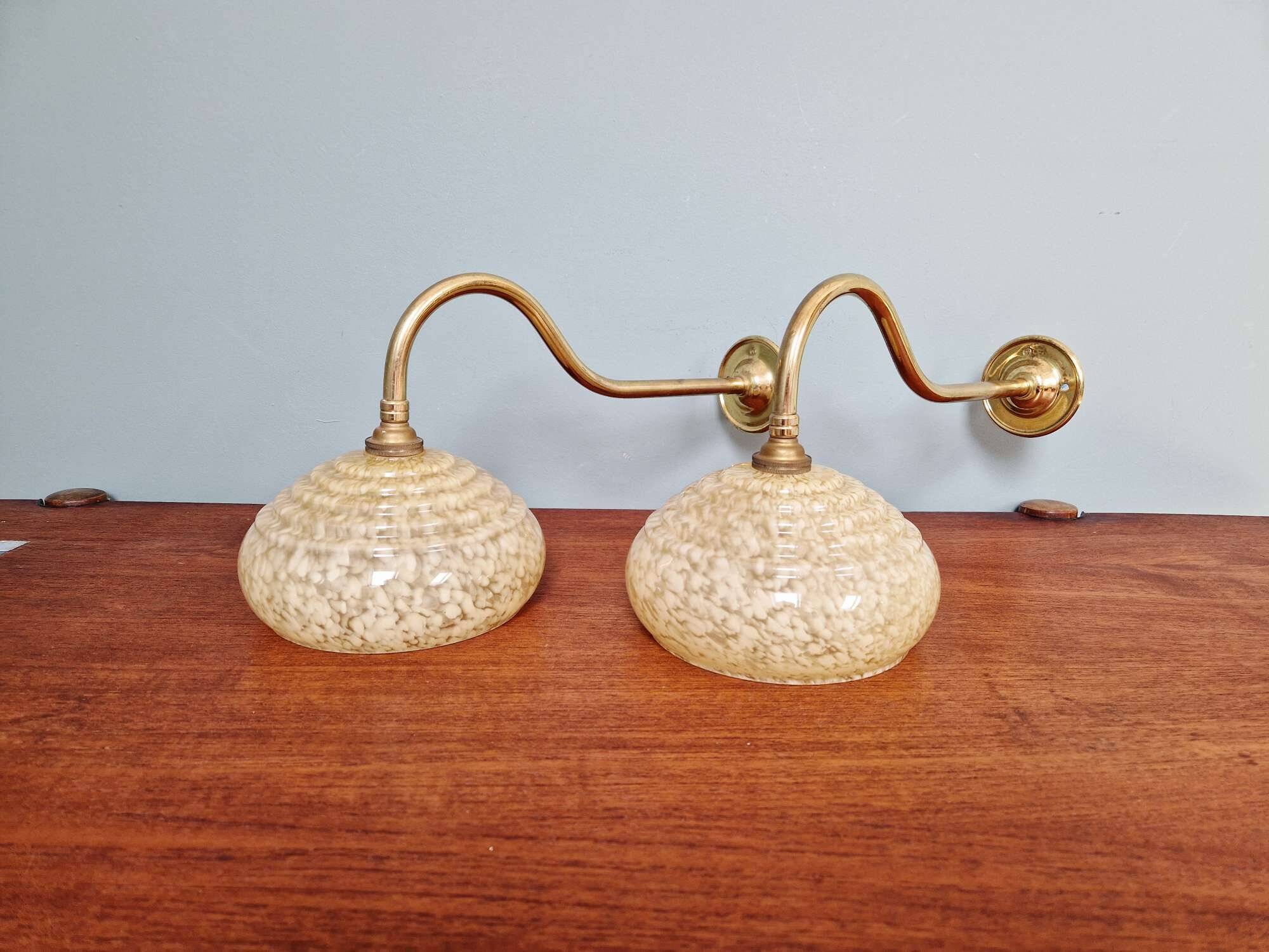 Pair of brass and yellow/white speckled glass wall sconces