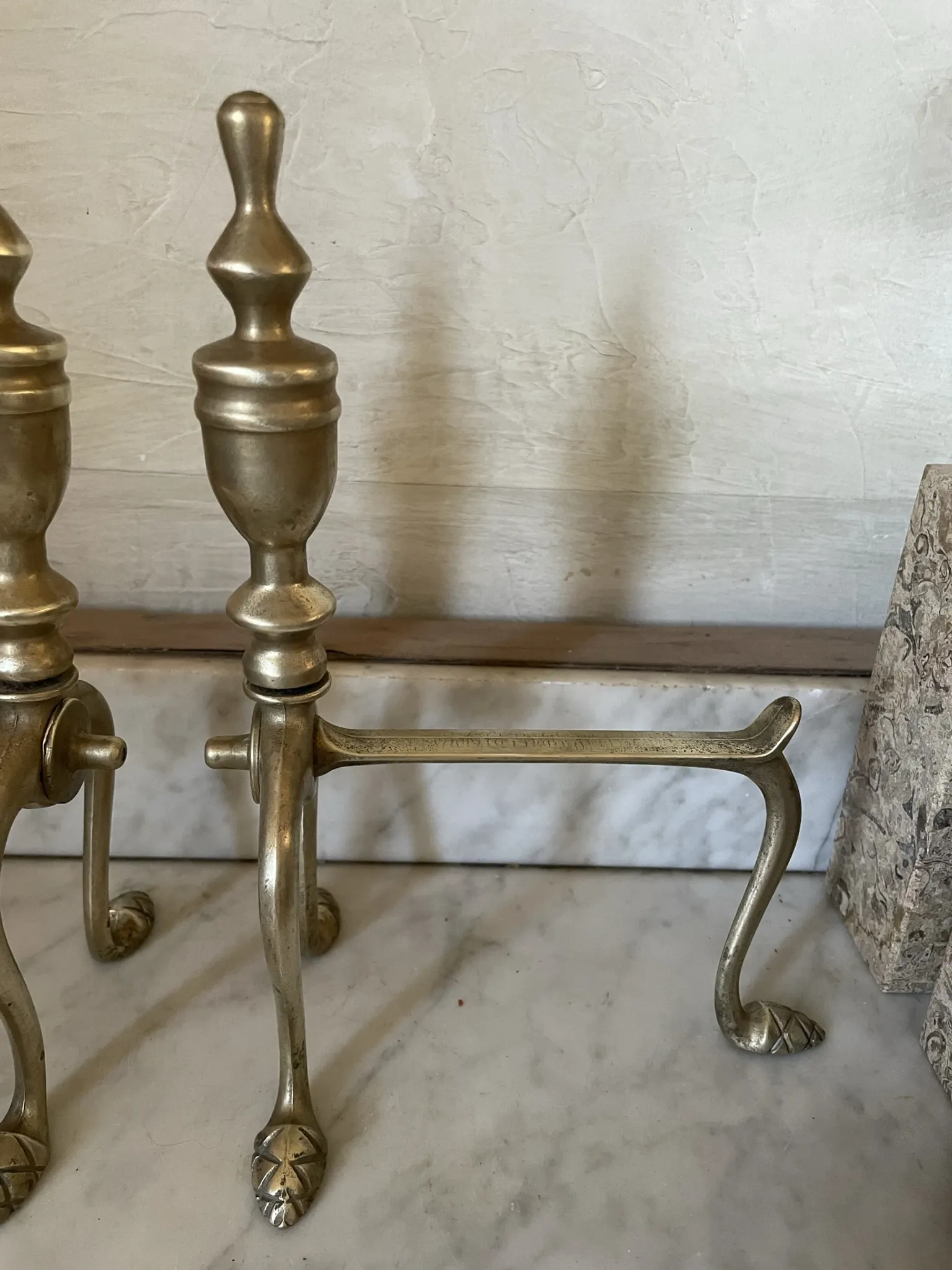 Pair of Victorian brass fire dogs from the late 19th century.