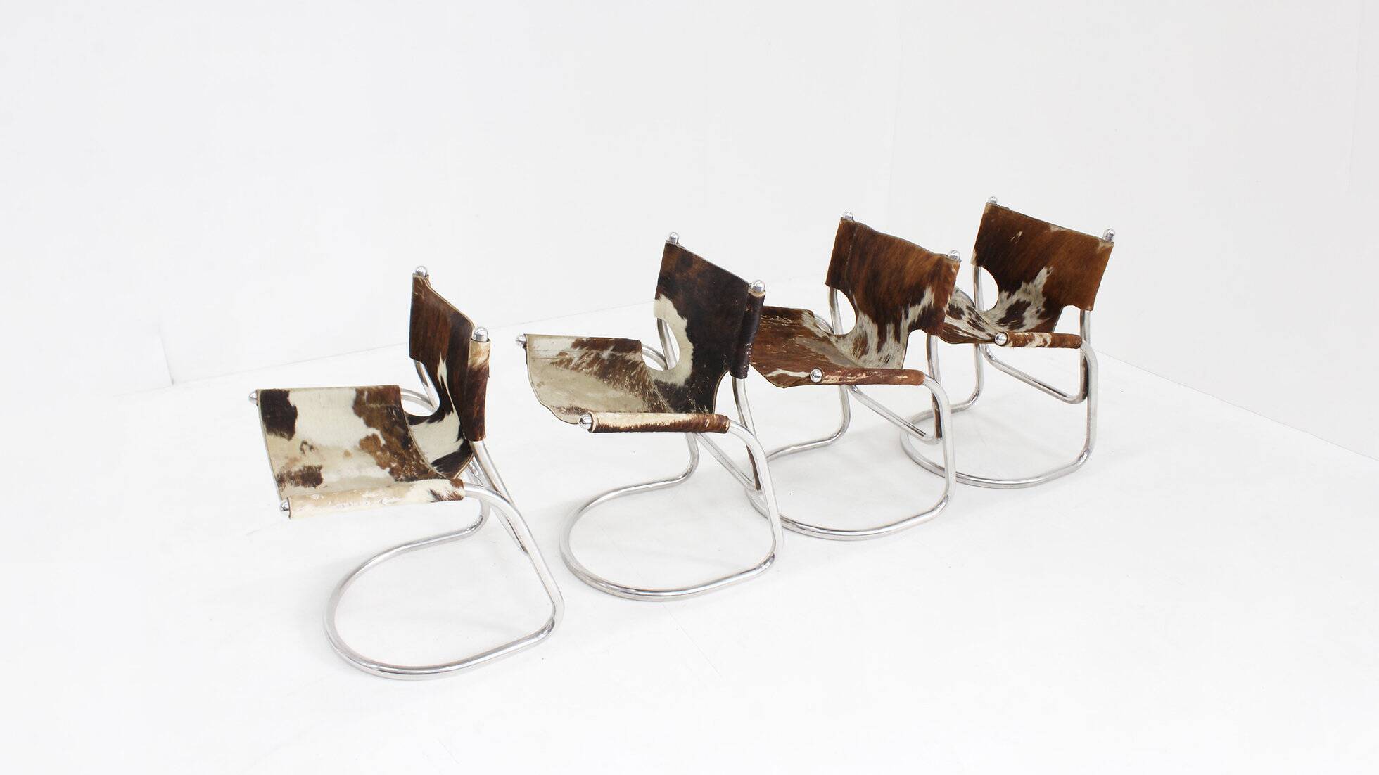 Vintage dining room chairs chrome and cowhide by Parravicini Fratelli