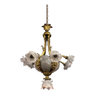 Rare and important gilded bronze chandelier with shells and roses.