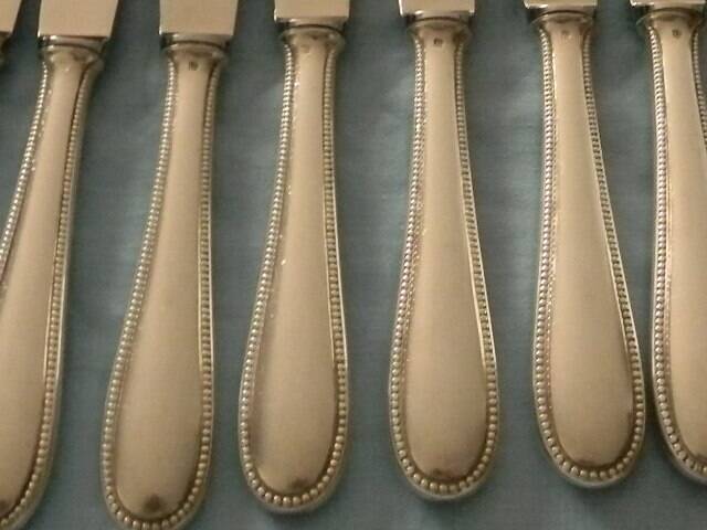 Set of 12 cheese or fruit knives with silver metal handles.