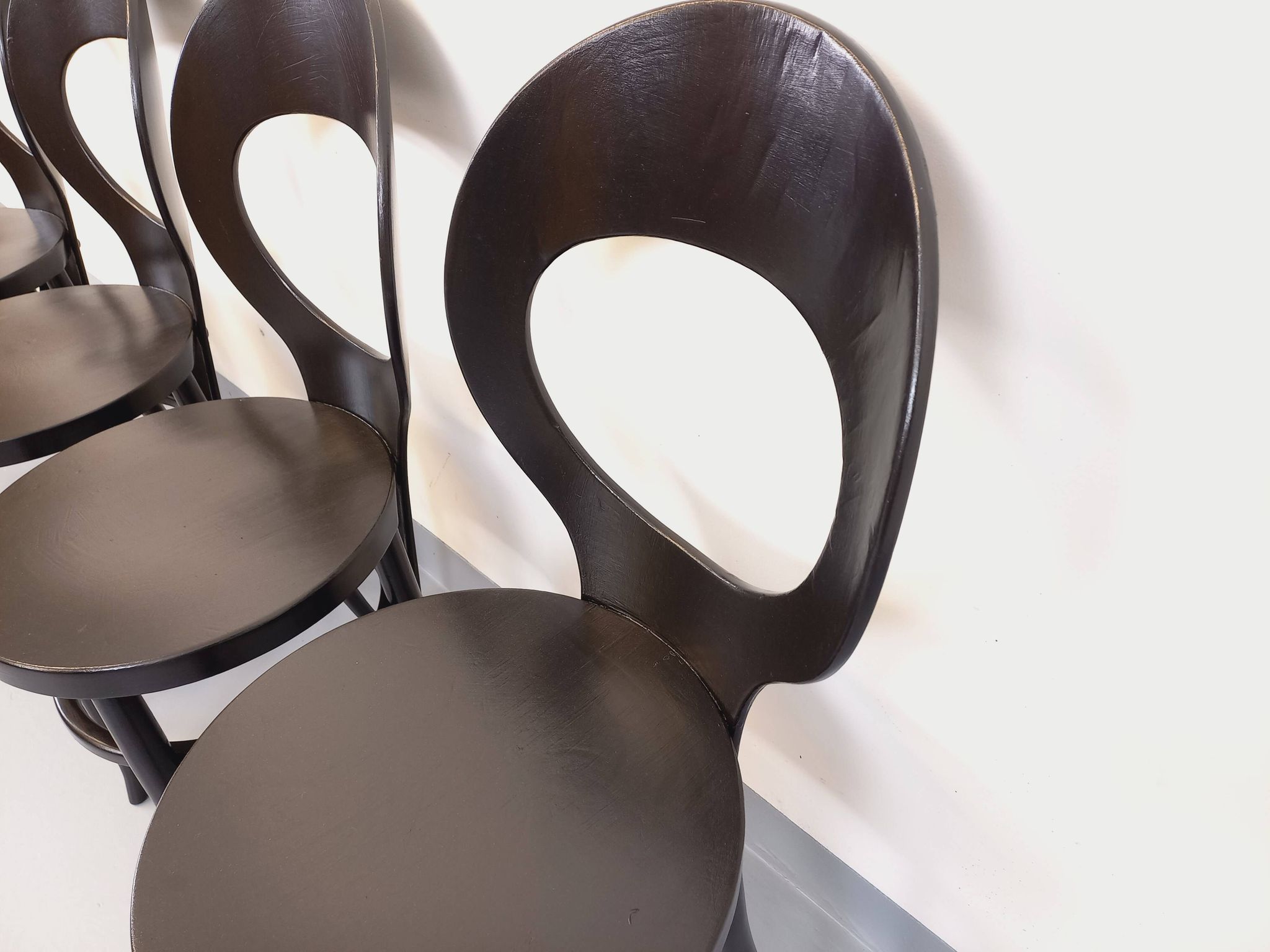 Set of 4 vintage Mouette chairs by Baumann in black wood from the 1960s.