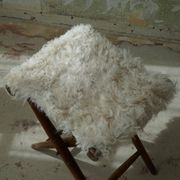 Folding stool, reupholstered in long-haired sheepskin, mid-century modern style, 1950s.