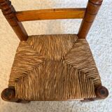 Old, rustic children's chair, small wooden and straw chair.