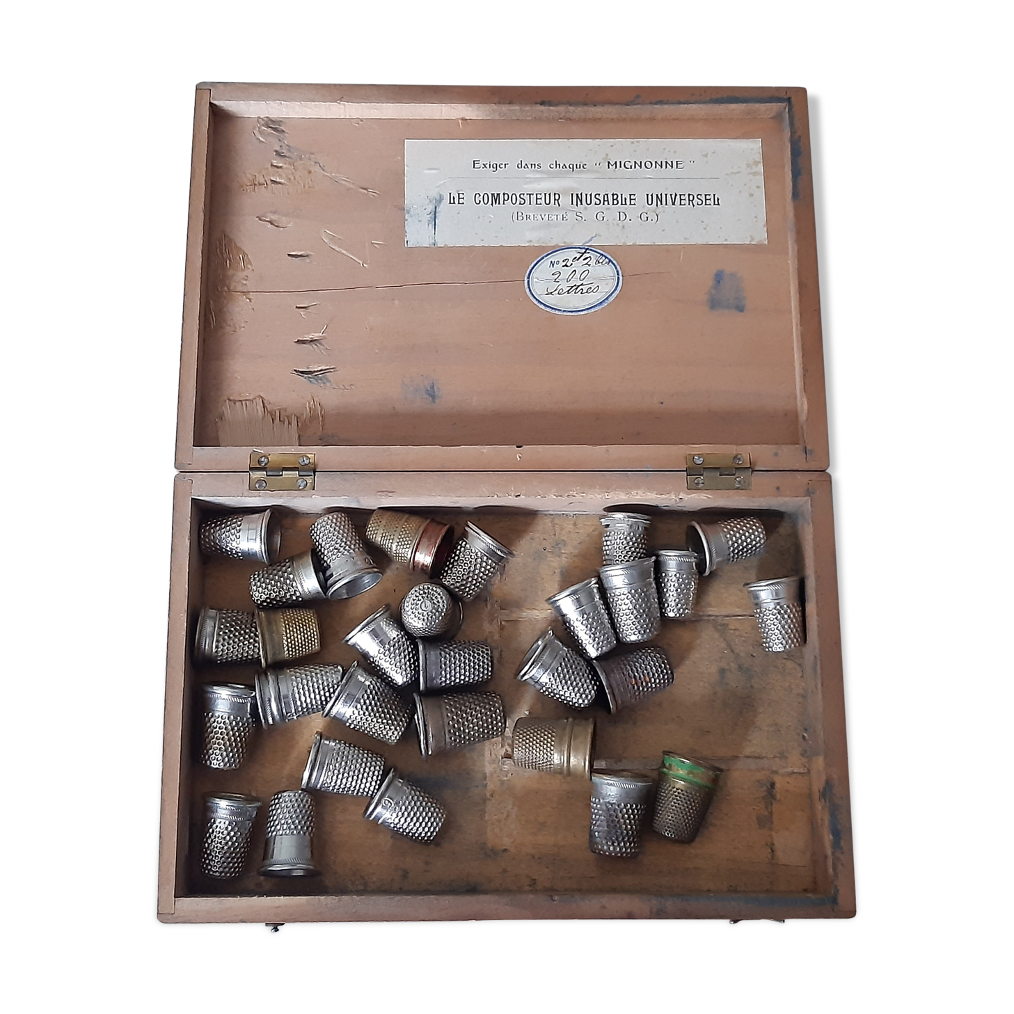 Wooden box containing 30 antique thimbles