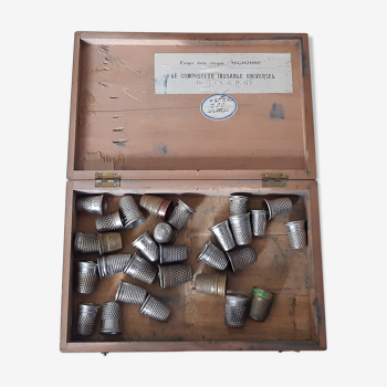 Wooden box containing 30 antique thimbles