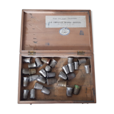 Wooden box containing 30 antique thimbles