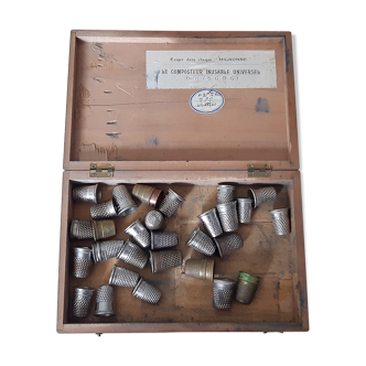 Wooden box containing 30 antique thimbles