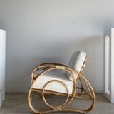 Large rattan rest chair and white cushions