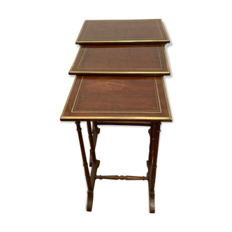 Three trundle tables in mahogany and brass fillet XX century