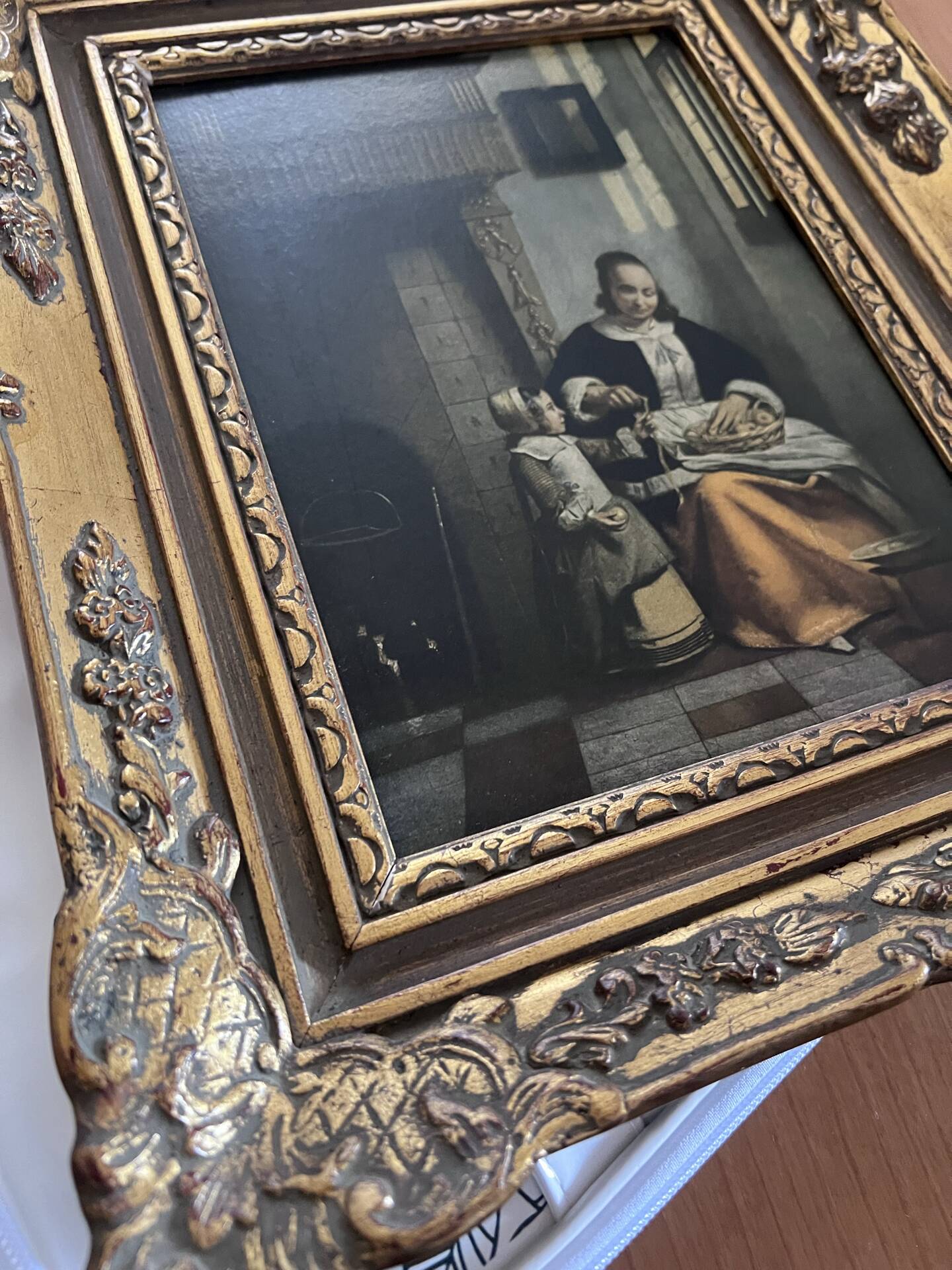 Framed reproduction painting with a golden frame.
