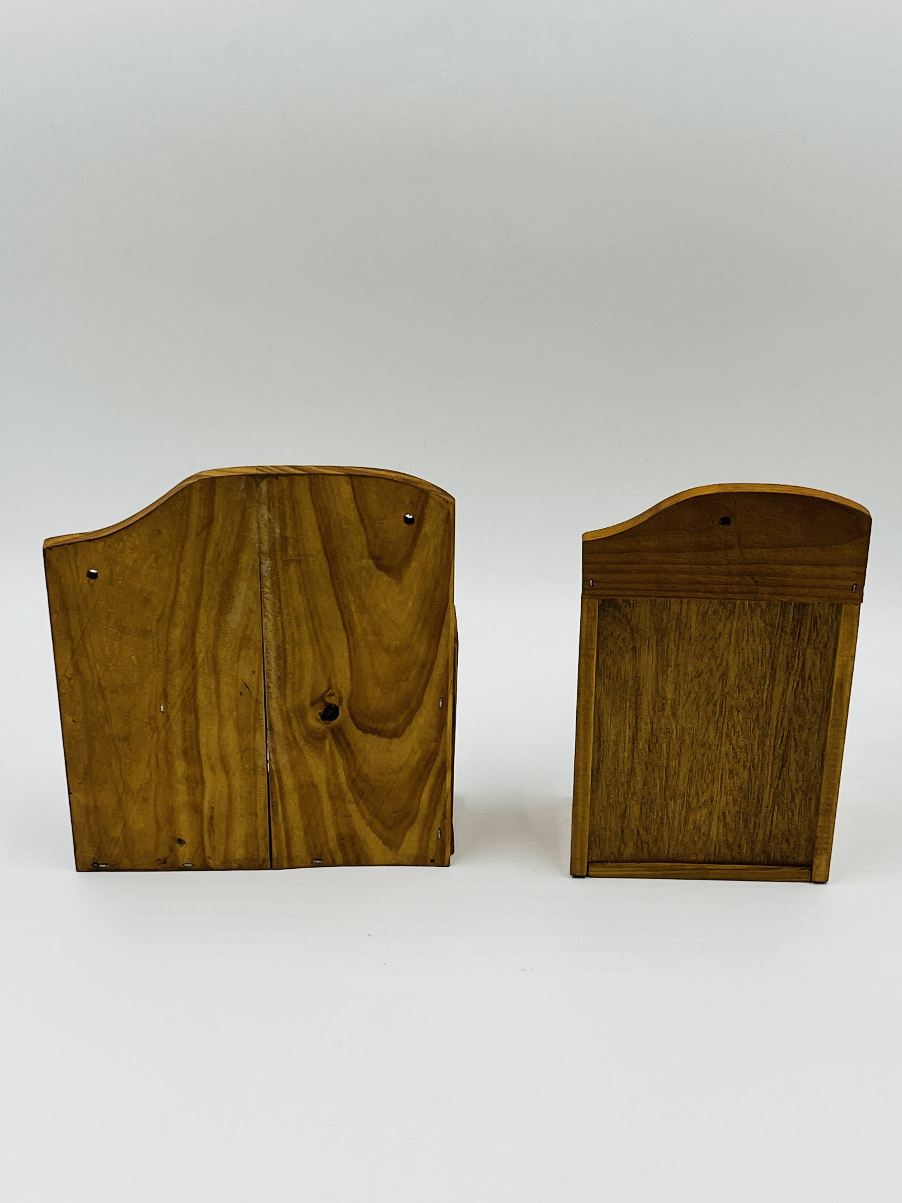 Wall-mounted egg cup holder and wooden utensil holder.