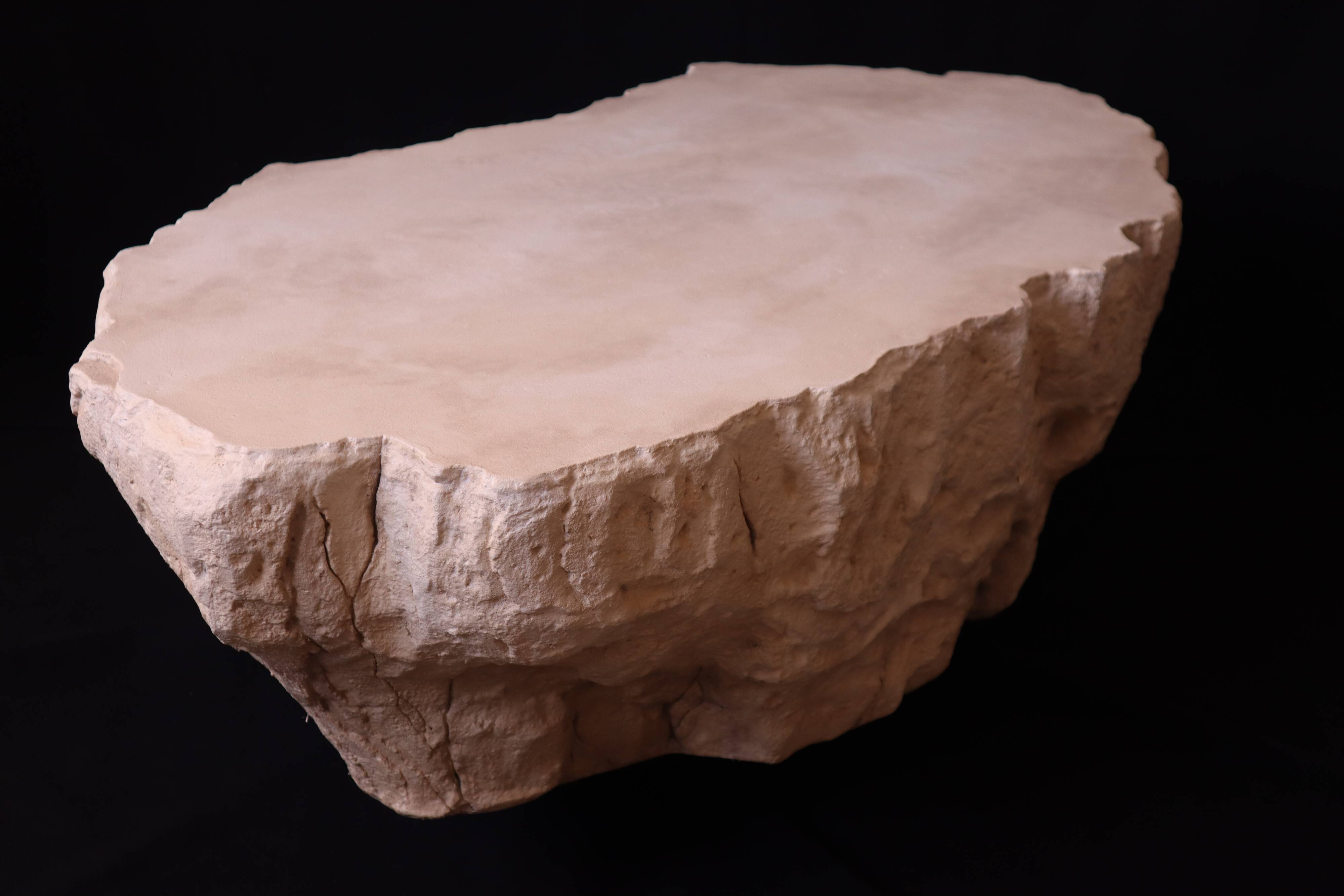 Designer coffee table with travertine rock effect — unique handcrafted piece.