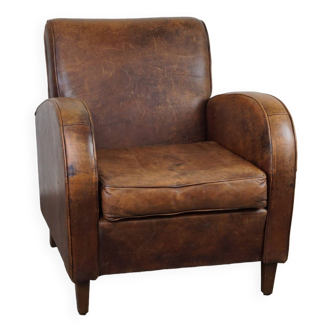 Sheepskin design armchair with a beautiful patina and comfortable seating