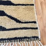 Handmade Moroccan rug in ecru with coloured patterns, 250cm x 150cm.