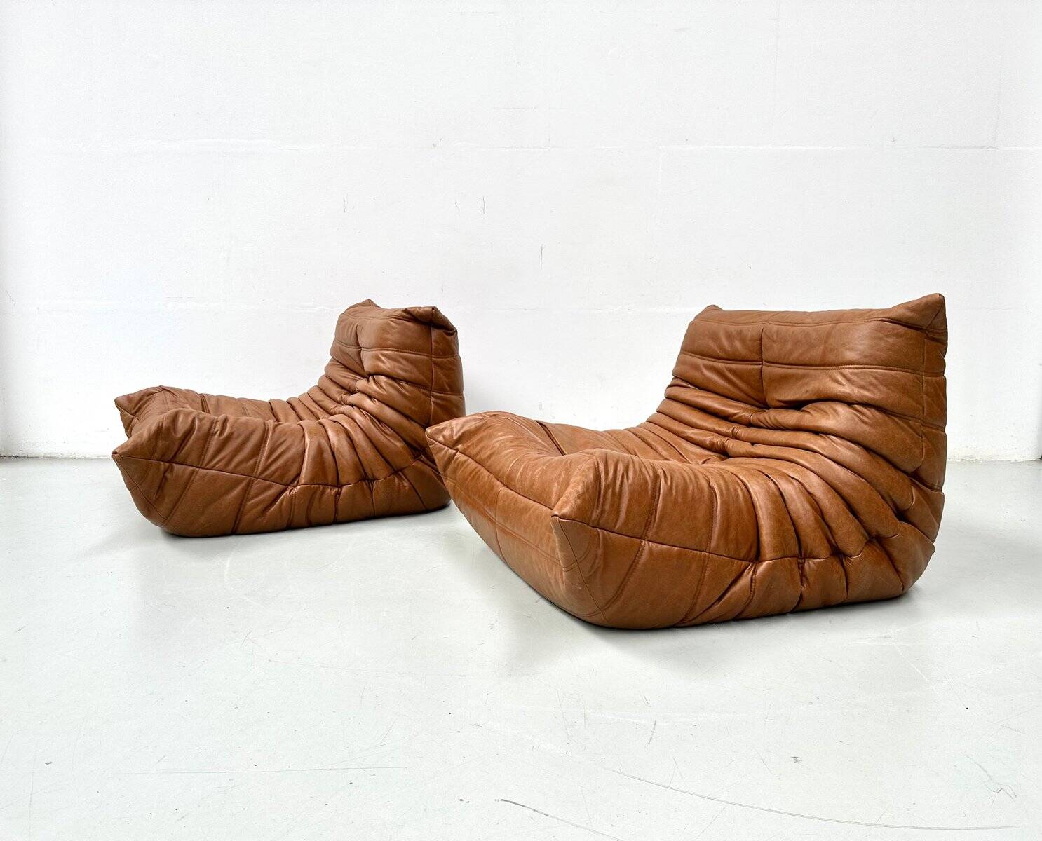 Togo lounge chairs in cognac cow leather attributed to Michel Ducaroy for Ligne Roset, set of 2