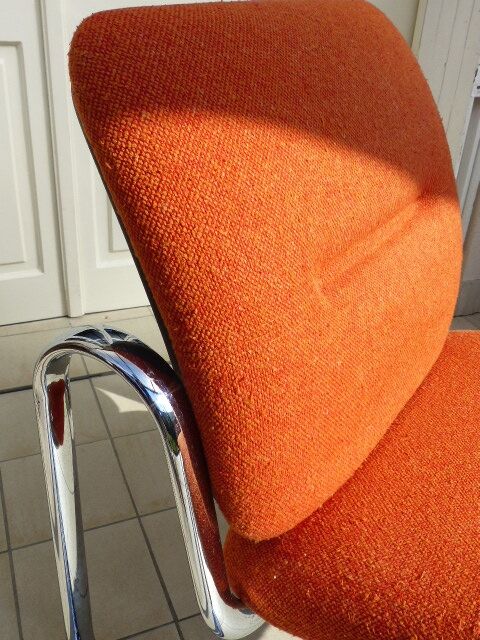 The 1970s orange armchair fabric and chrome metal