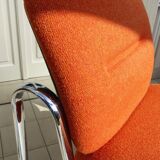 The 1970s orange armchair fabric and chrome metal