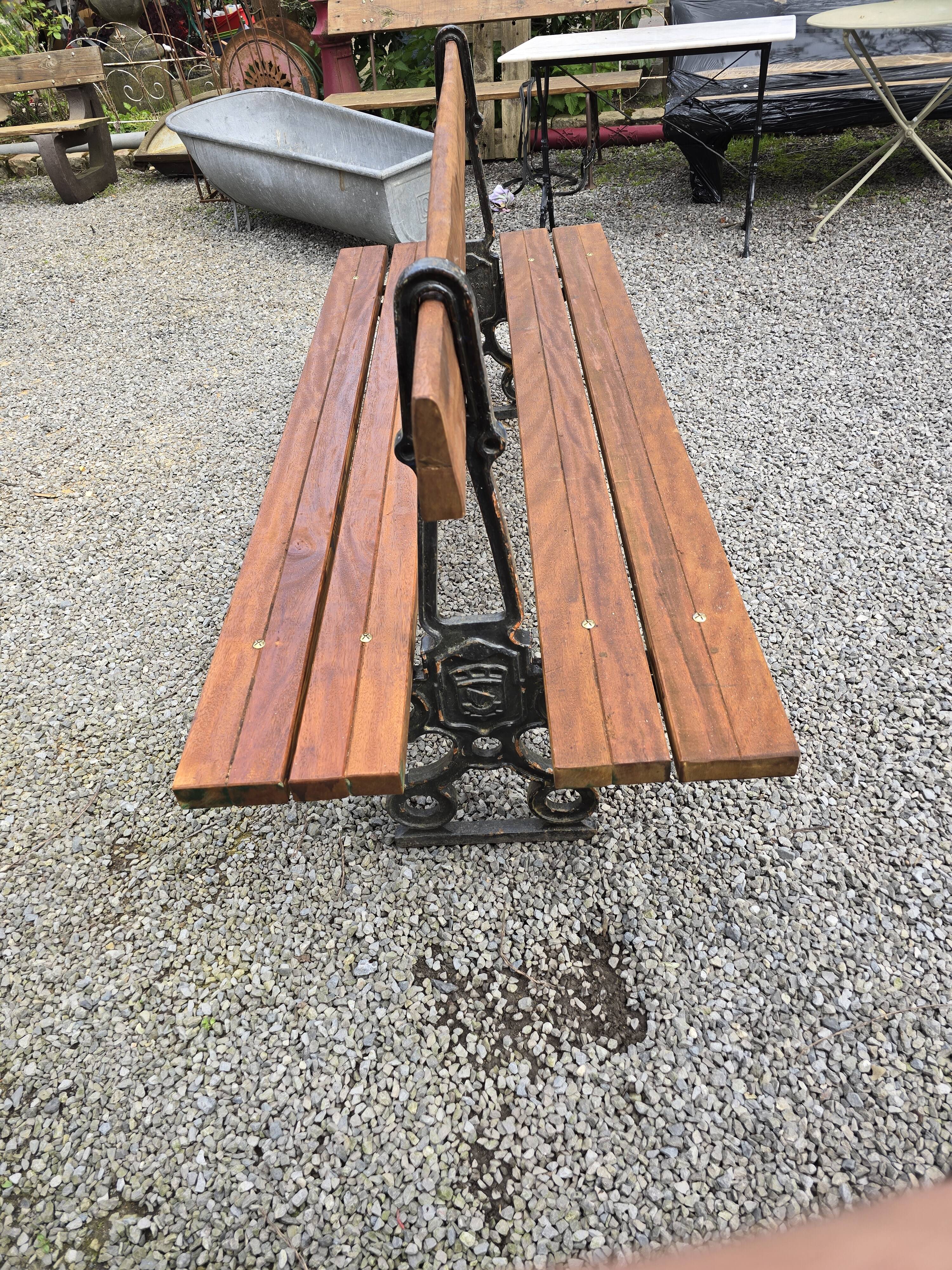 Antique double garden bench from the city of Paris in cast iron and wood
