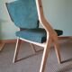 Scandinavian green chairs with tapered legs.