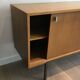 Sideboard with double sliding doors and bar on a metal base