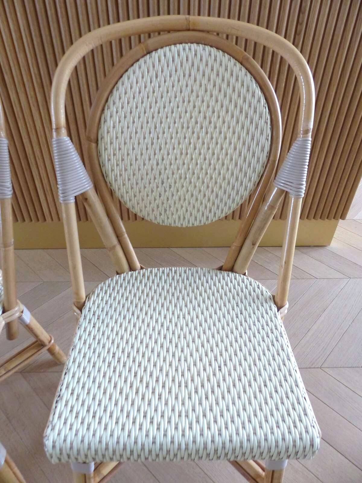 Pair of Parisian bistro chairs from Maison Louis Drucker in light Manila rattan.