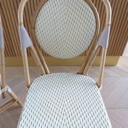 Pair of Parisian bistro chairs from Maison Louis Drucker in light Manila rattan.