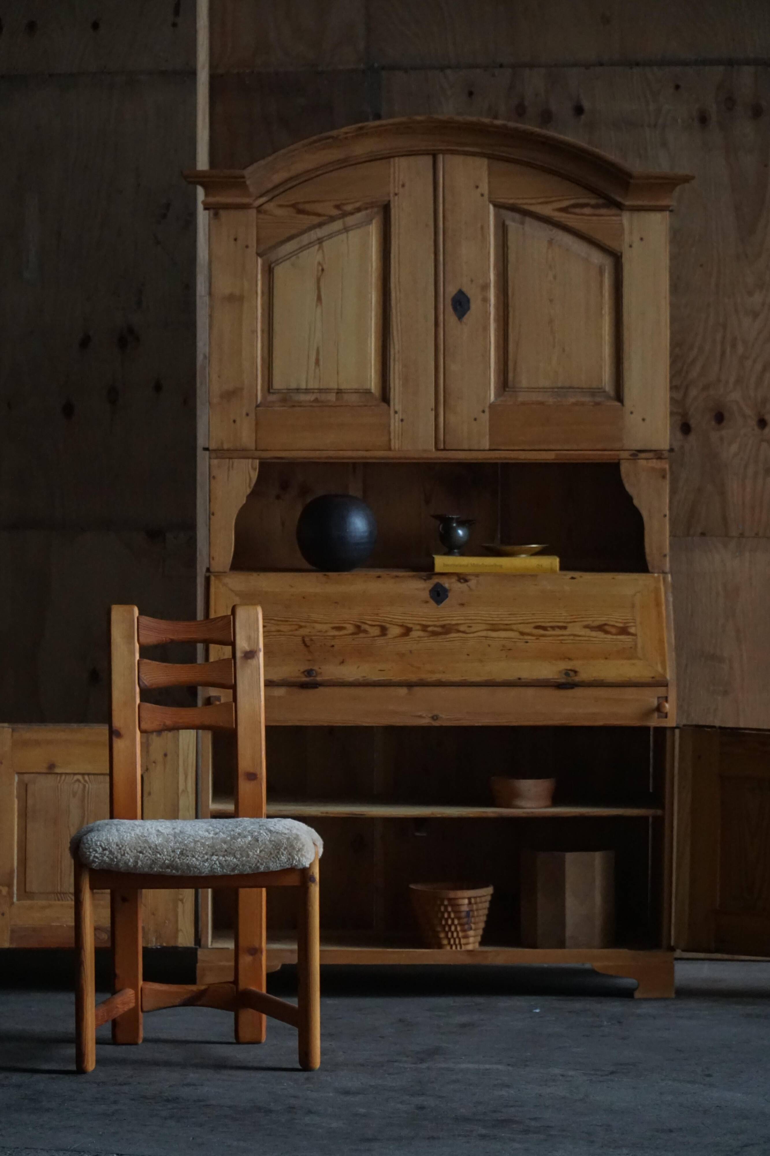 Old Danish secretary in pine with drop-down front and upper cabinet, mid-19th century.