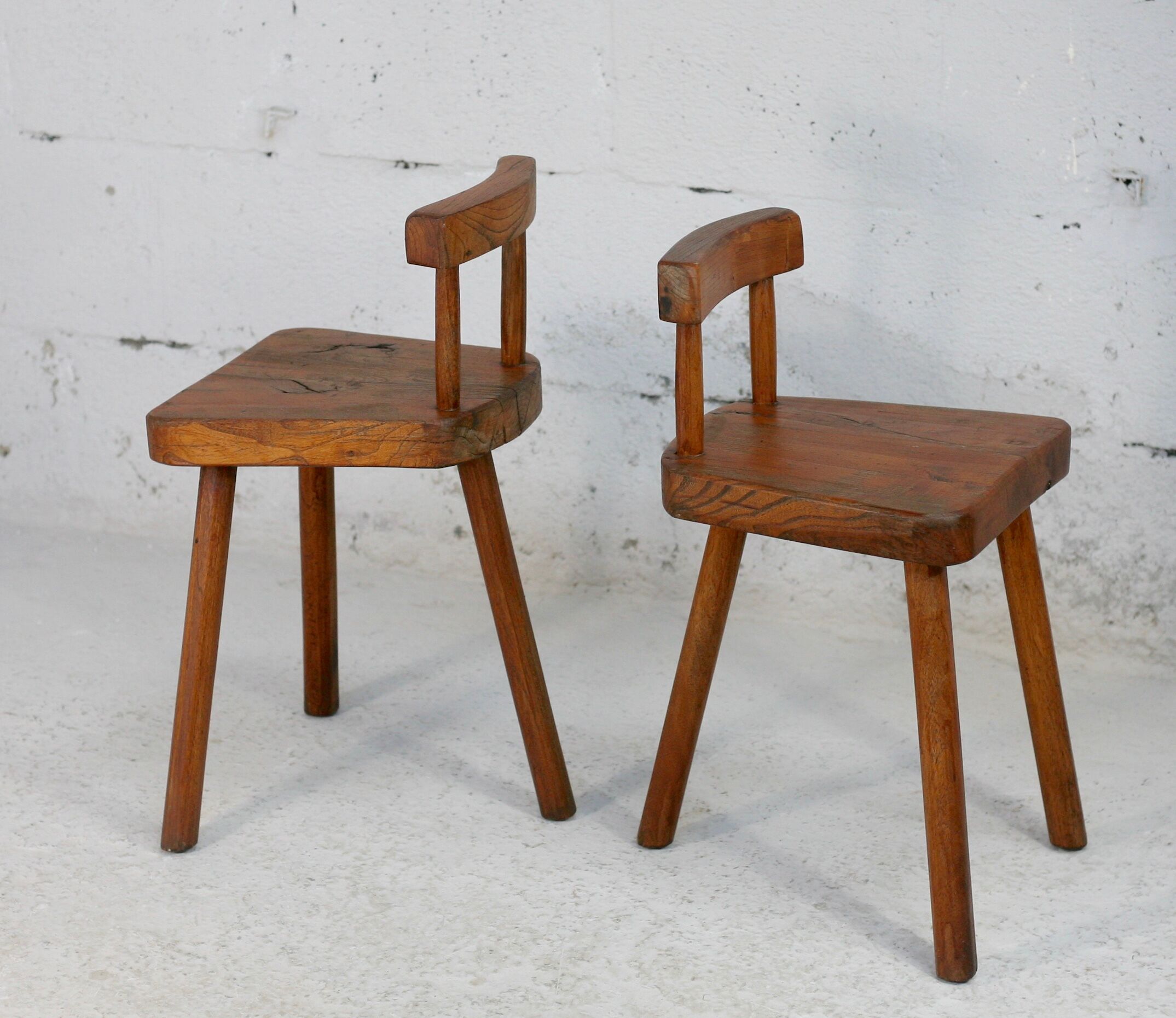Pair of tripod stools with brutalist backrests, France, circa 1960