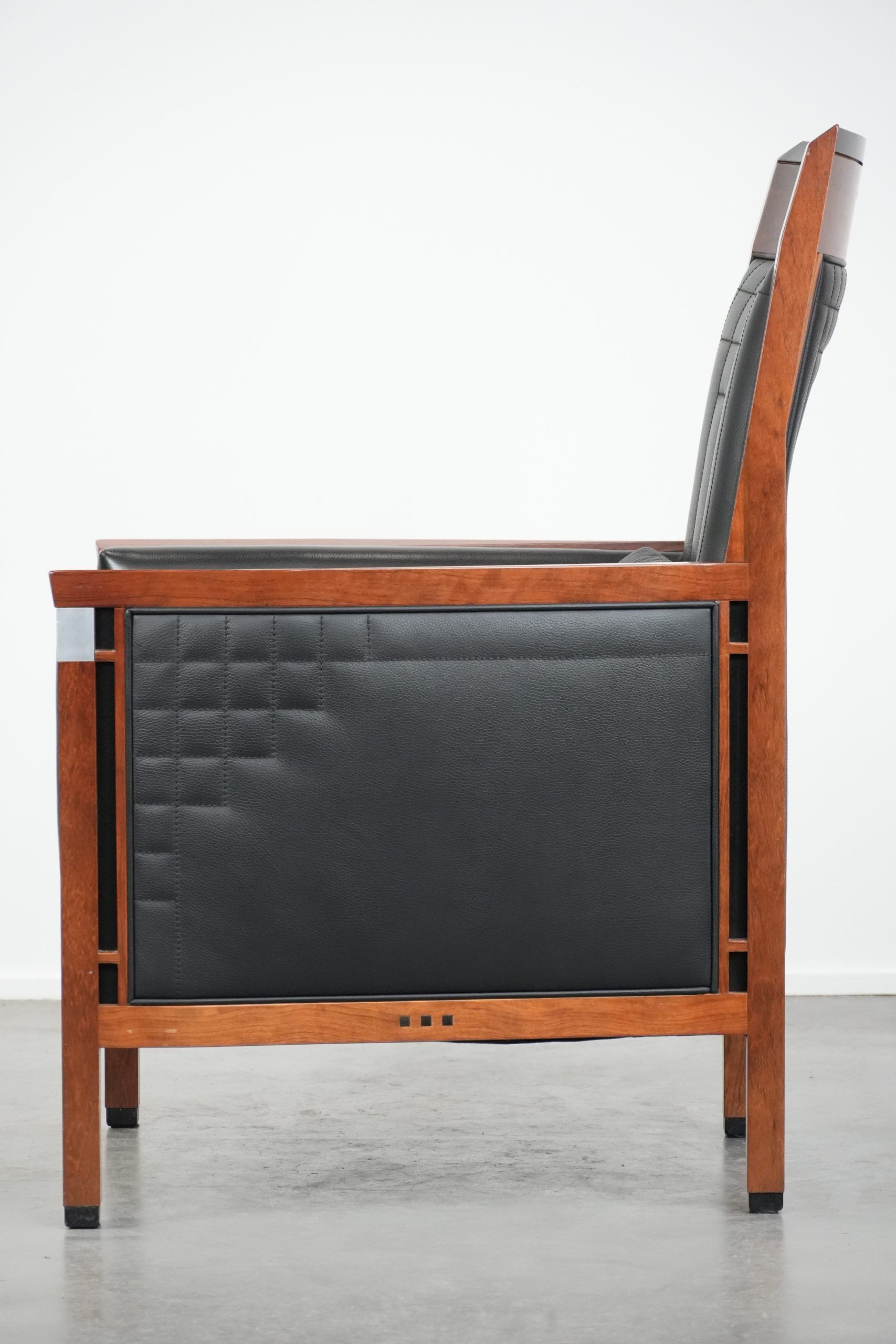 Art Deco design armchair with black leather with decorative stitching