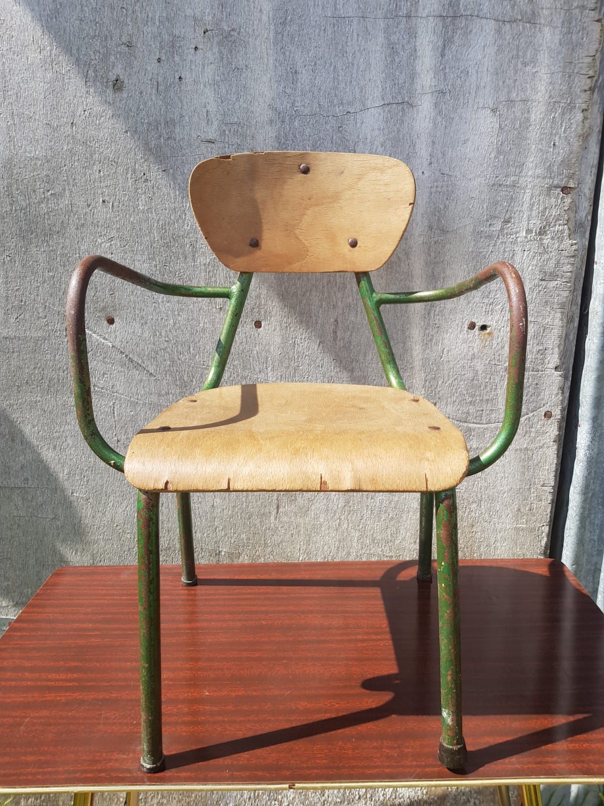 Former green metal child chair