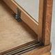 Antique Dutch oak display cabinet with glass shelves and a mirrored back