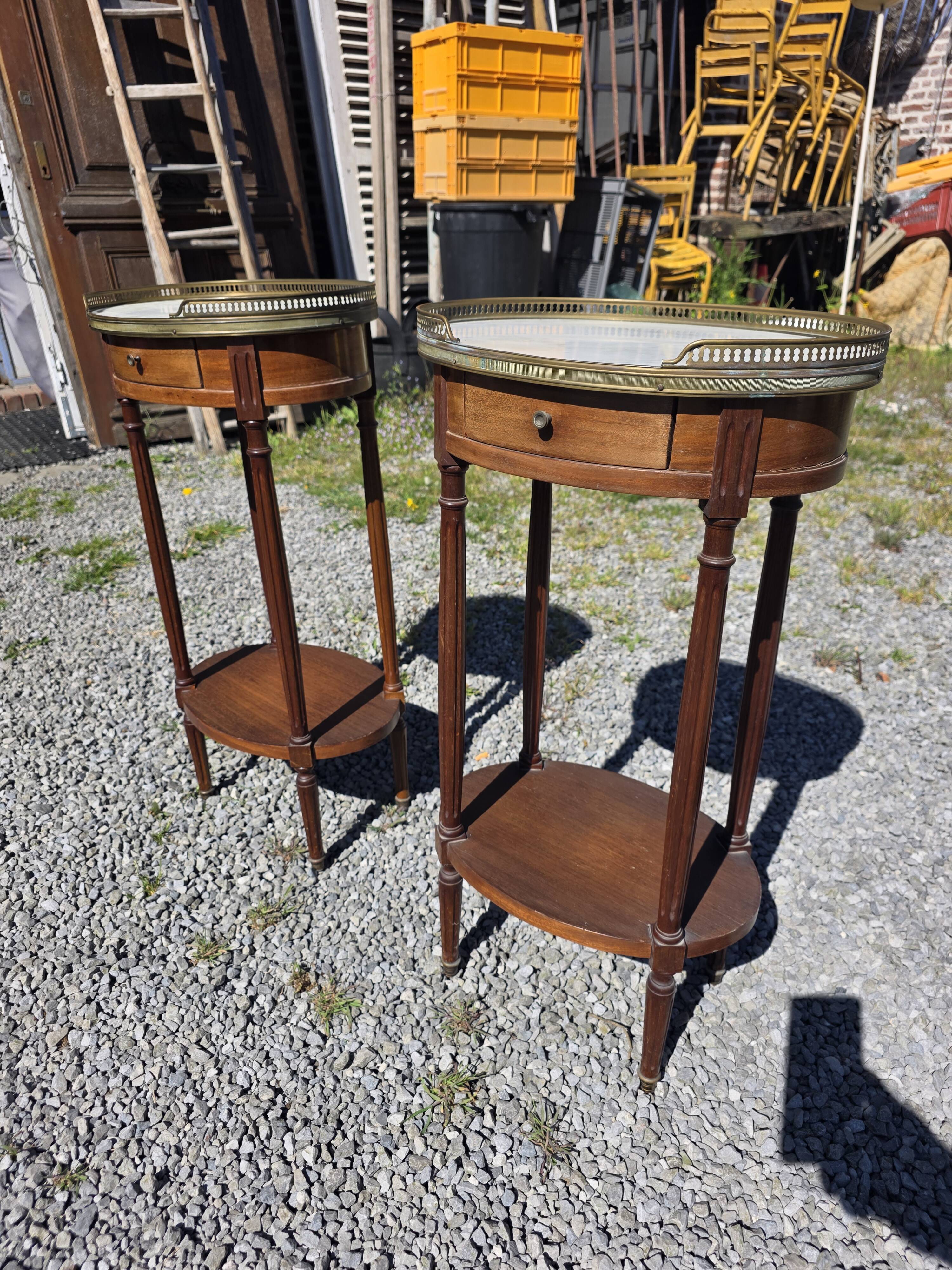 Pair of Louis XVI style bedside tables in mahogany, with marble tops.