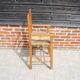 Old wooden high chair for children with straw.