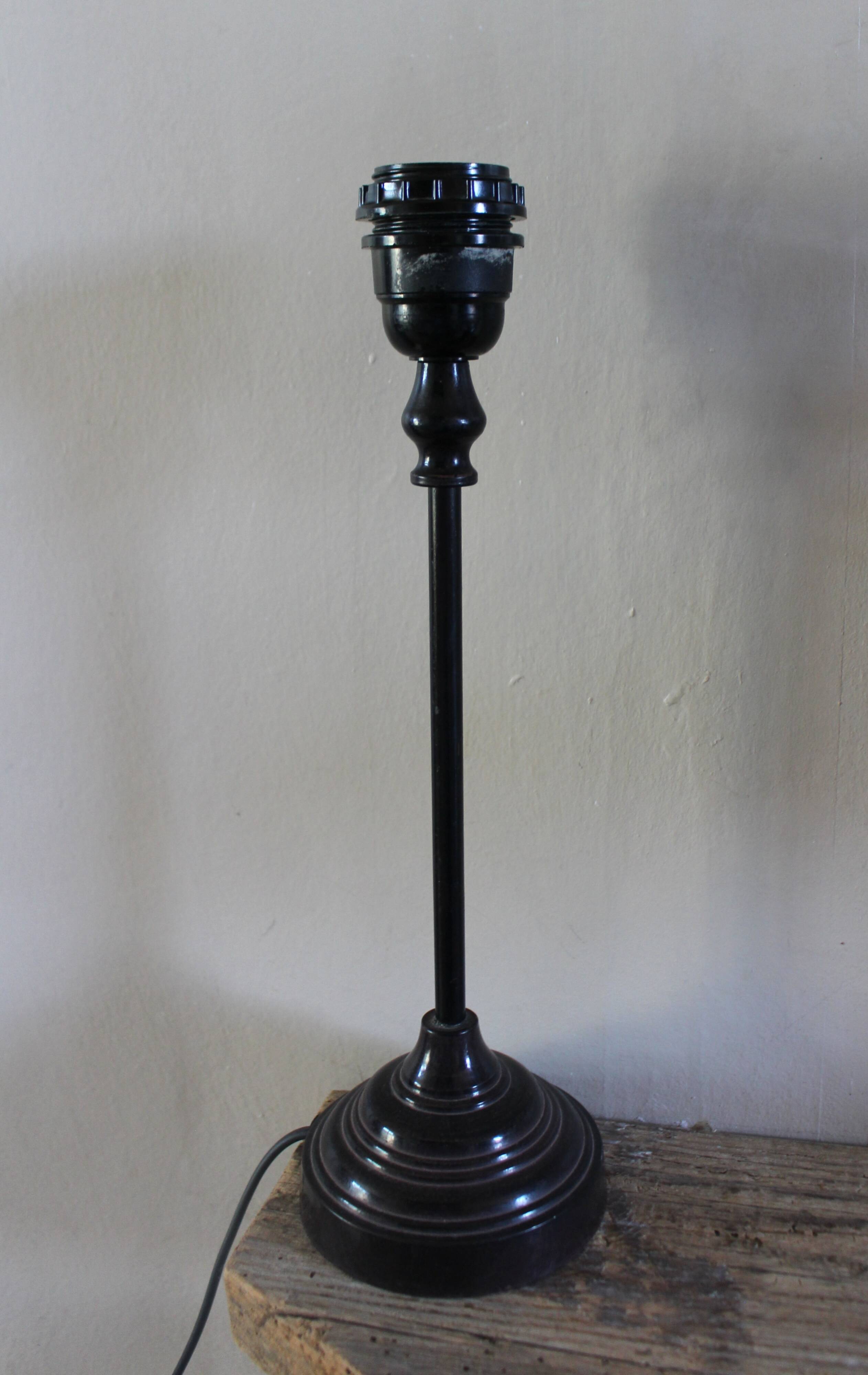 Table lamp with a patinated base and vintage woven shade.
