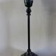 Table lamp with a patinated base and vintage woven shade.