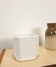 White vintage pot cover with stripes