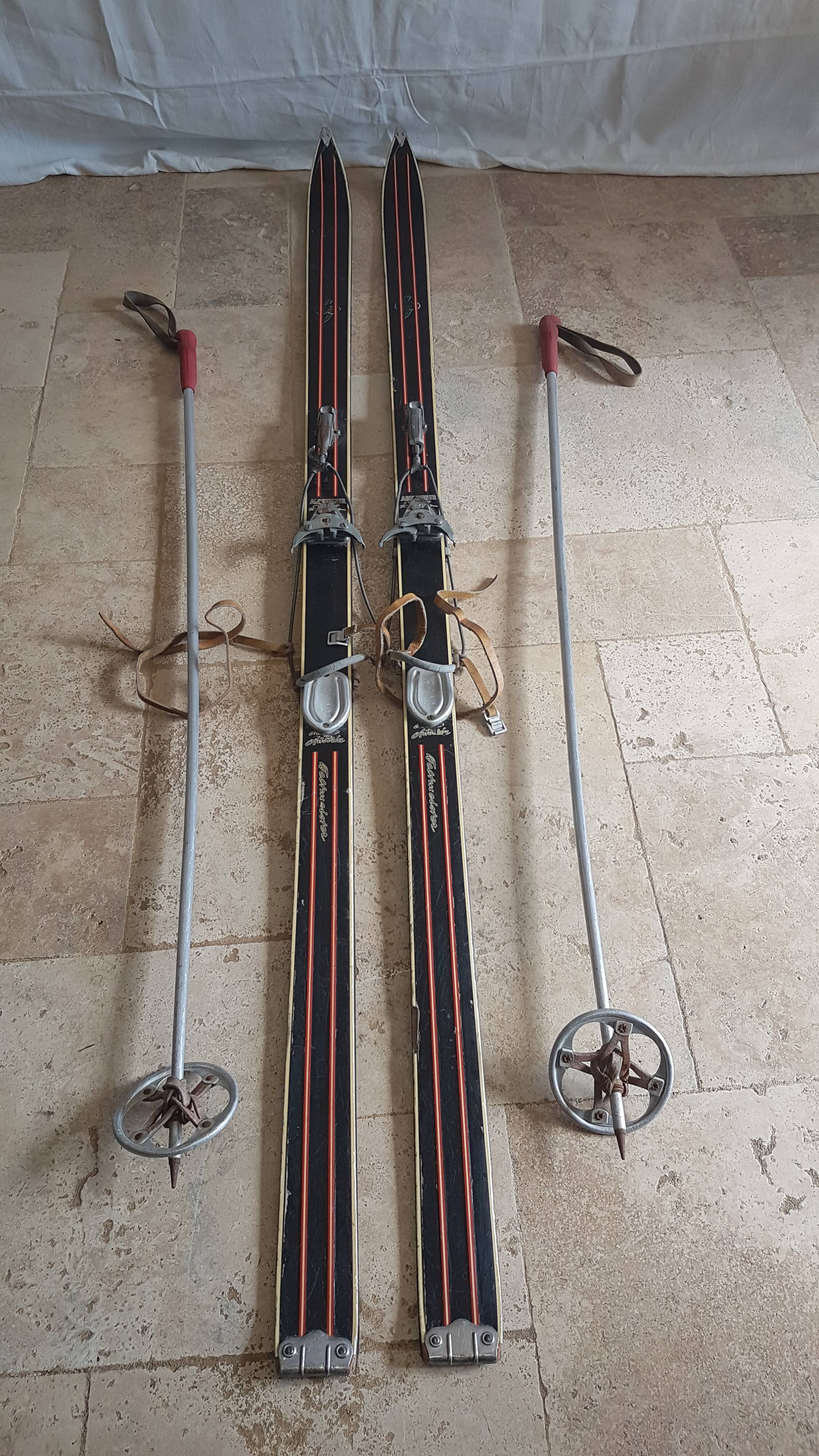 Old skis wooden and its pair of sticks