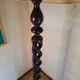 Sculptural floor lamp made of twisted turned wood.