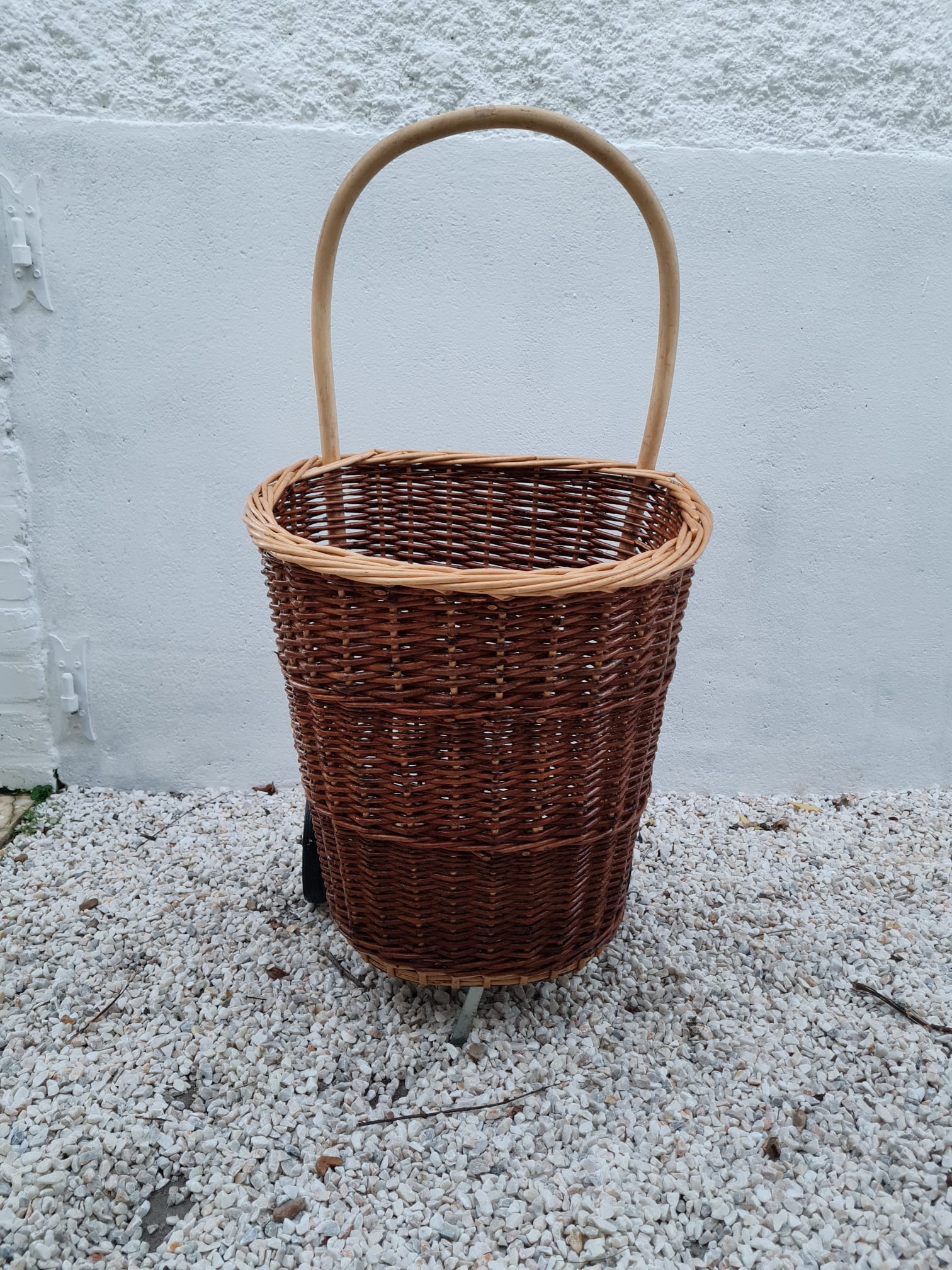 Vintage wicker log basket on vintage wheels