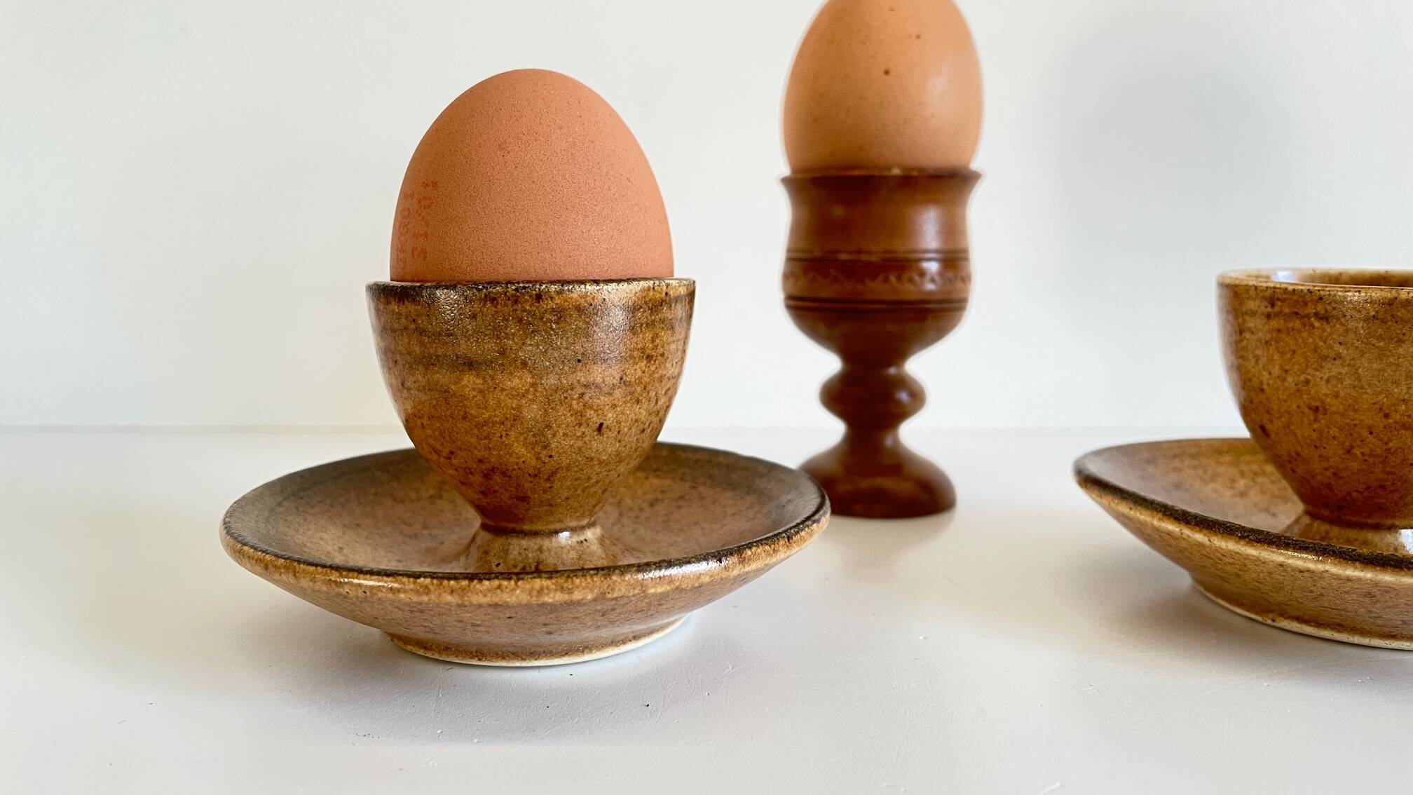 Trio of vintage ceramic and wood egg cups
