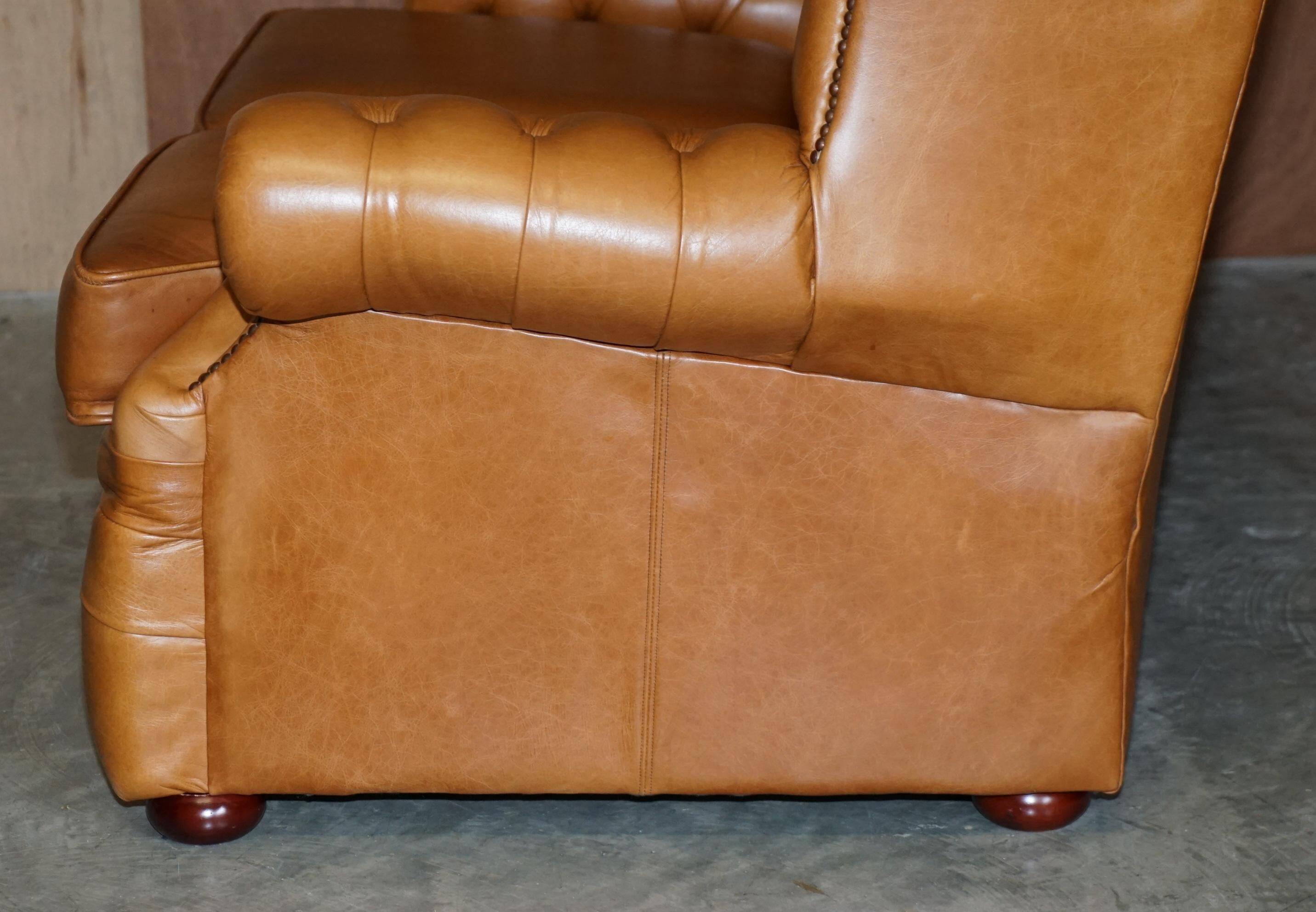 Small Chesterfield leather sofa with a high back.