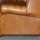 Small Chesterfield leather sofa with a high back.
