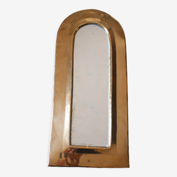 Rounded brass mirror