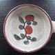 Frying pan with red fruit decoration
