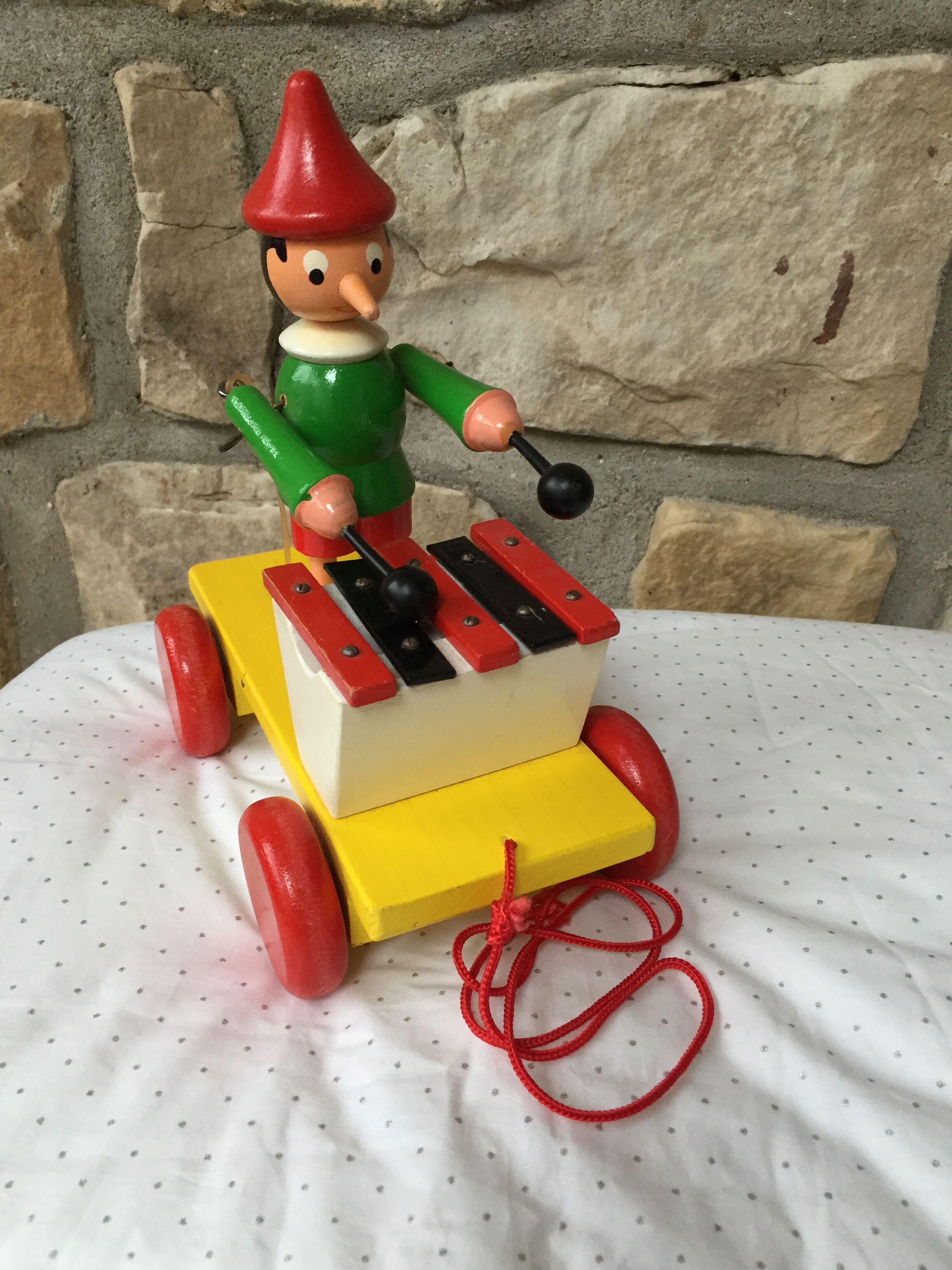 Old toy to pull Pinocchio and his xylophone